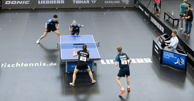 Table tennis players in a match