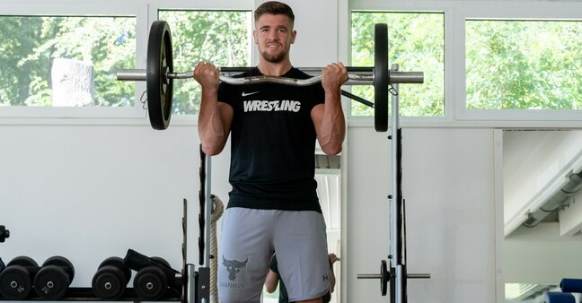 Athlete trains with weights in the weight room